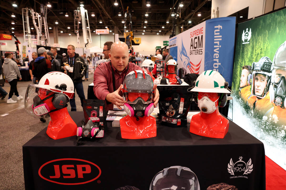 Greg Sesny of Huntersville, N.C. shows safety equipment in the JSP Safety Inc. booth on Day 1 o ...