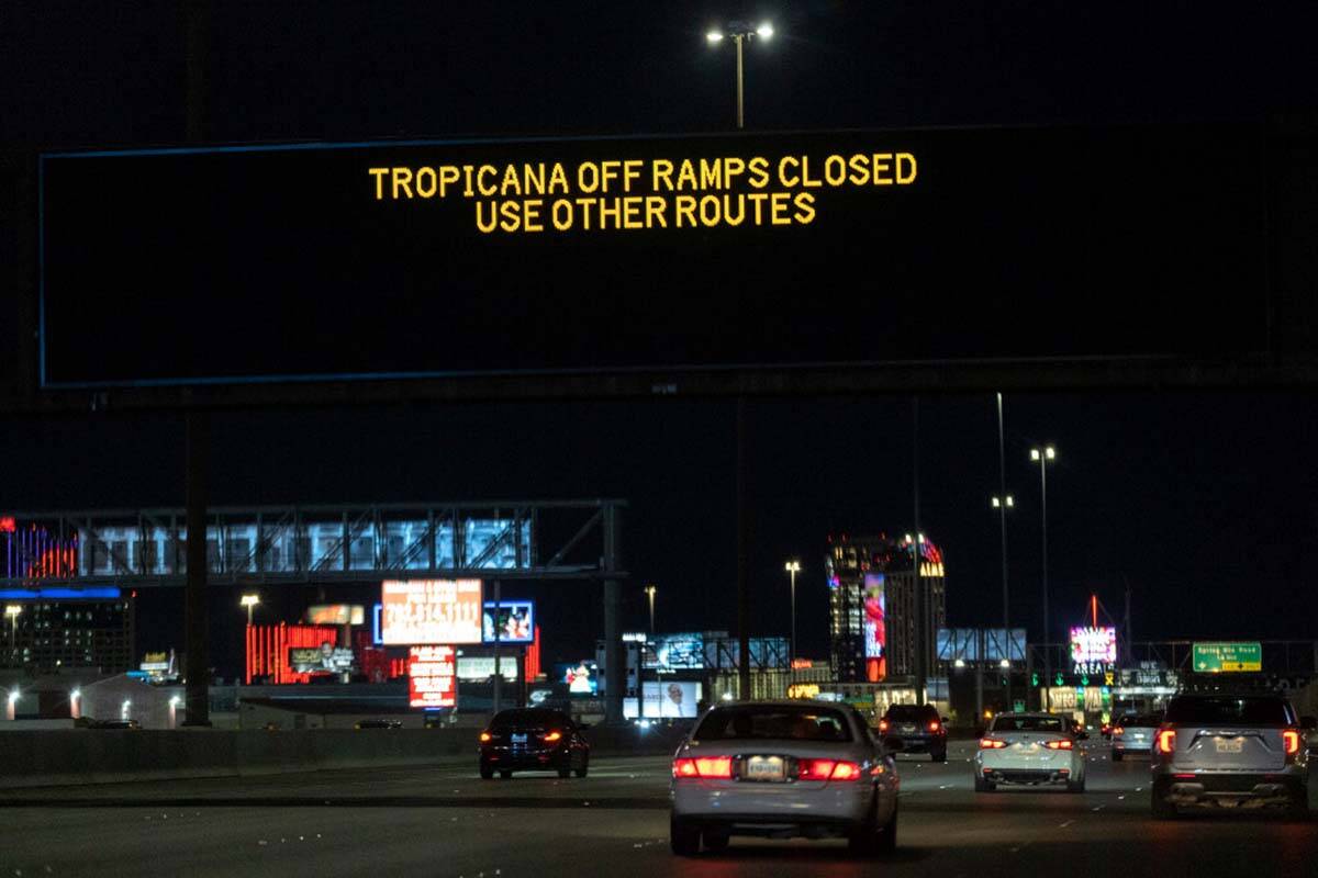 Signs along northbound I-15 warn motorists that the Tropicana Avenue bridge exits are closed on ...