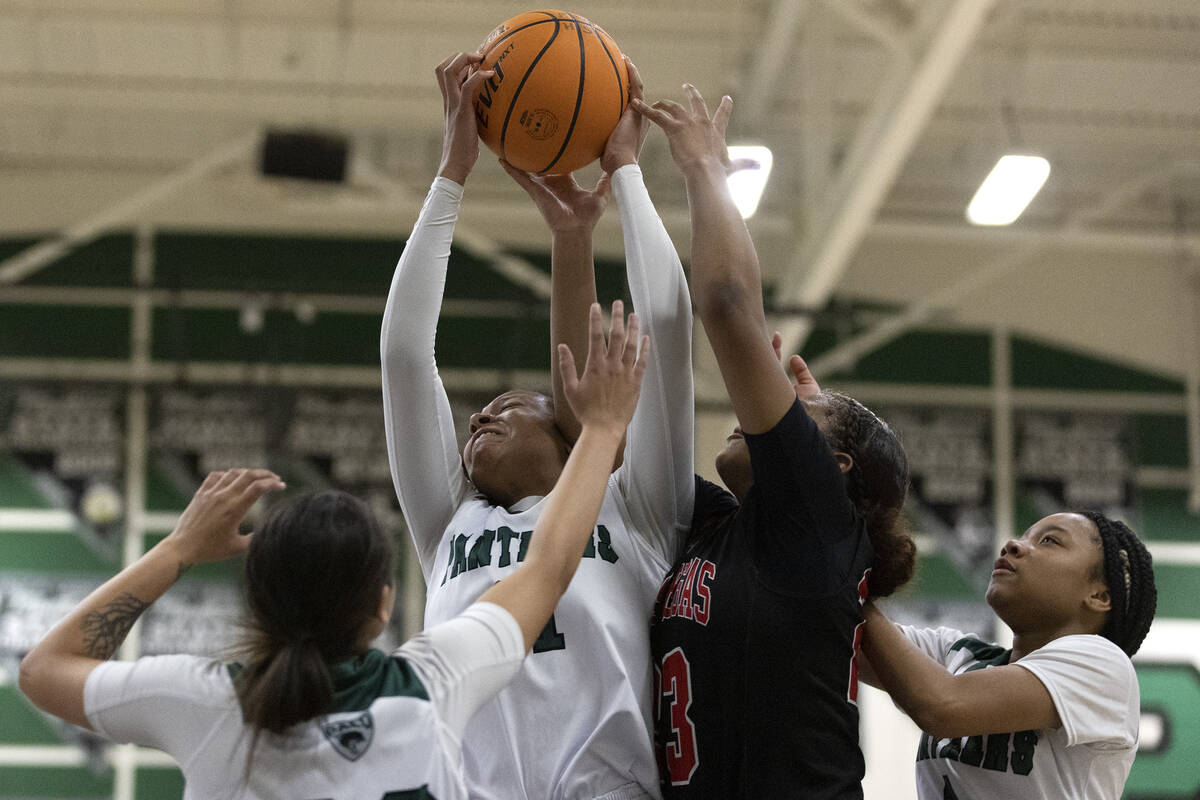 Palo Verde’s Tahira Lynch, center left, snags a rebound from Las Vegas’ Kayla Ter ...