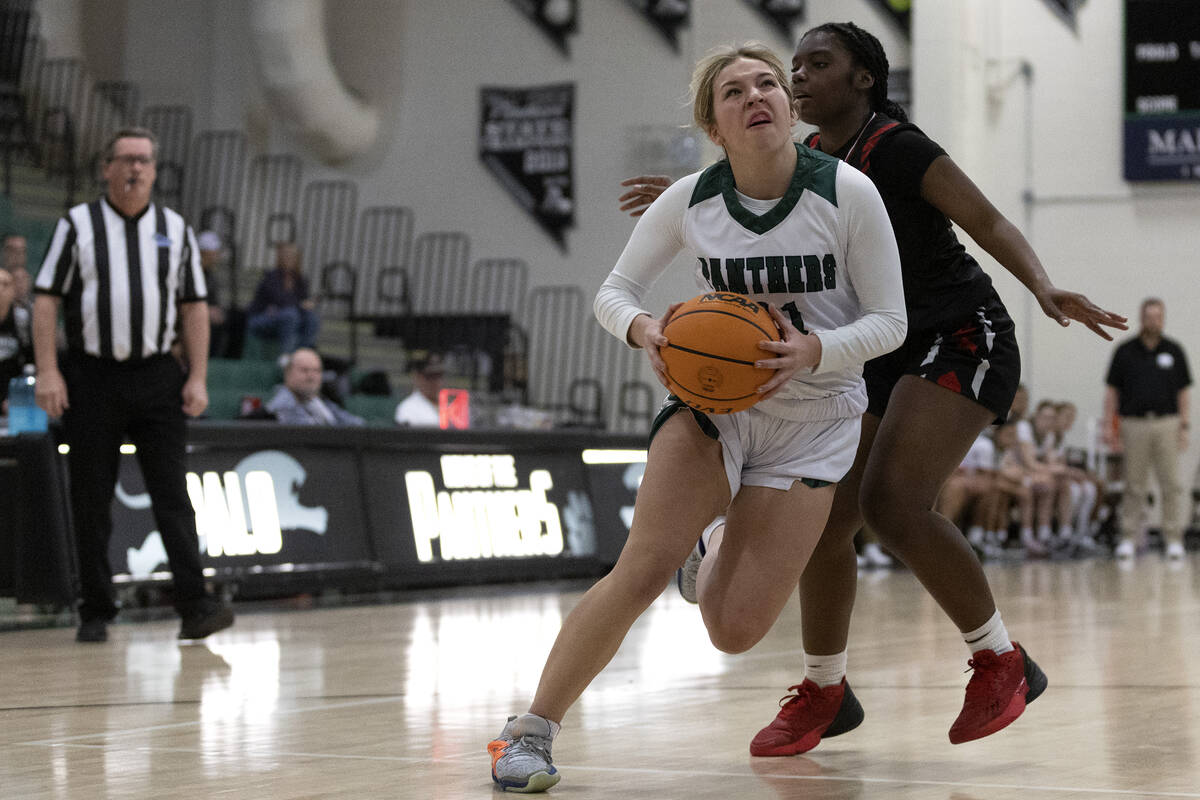 Palo Verde’s Halle McKnight, left, moves toward the hoop against Las Vegas’ Jorda ...