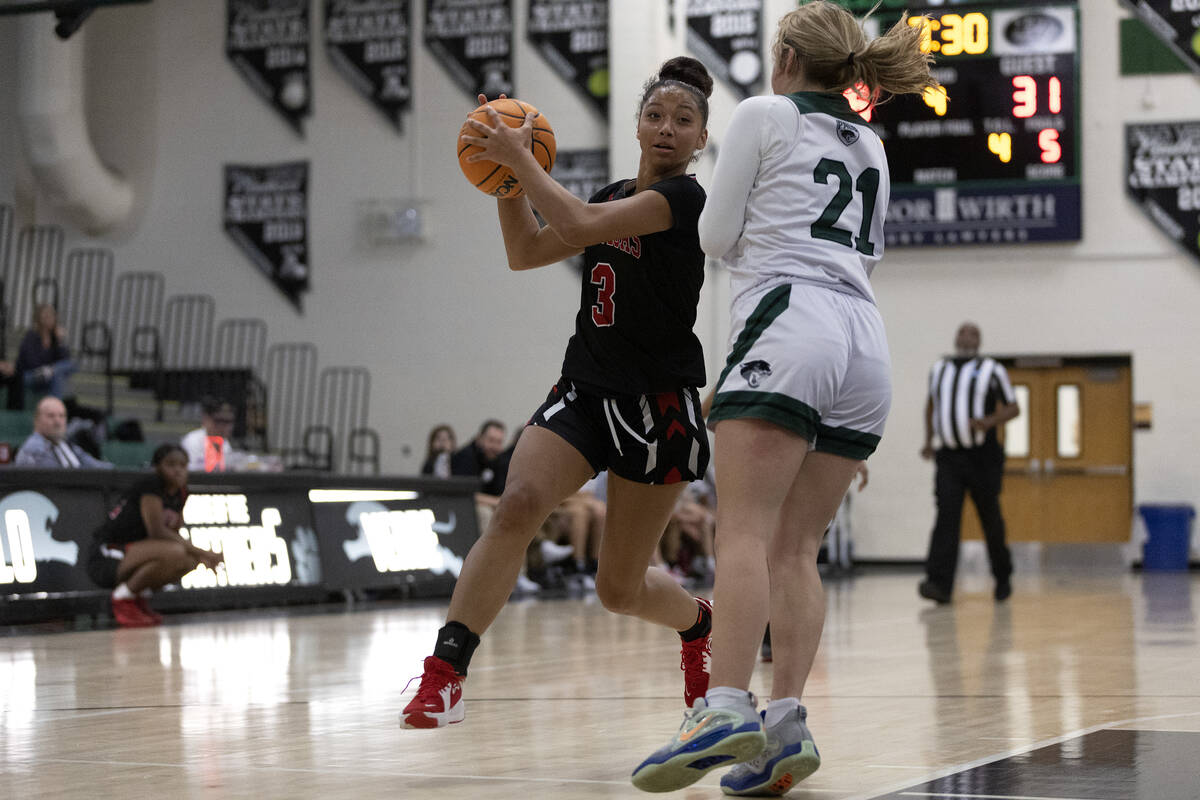 Las Vegas’ Vernonie Newson (3) drives around Palo Verde’s Halle McKnight (21) during a girl ...