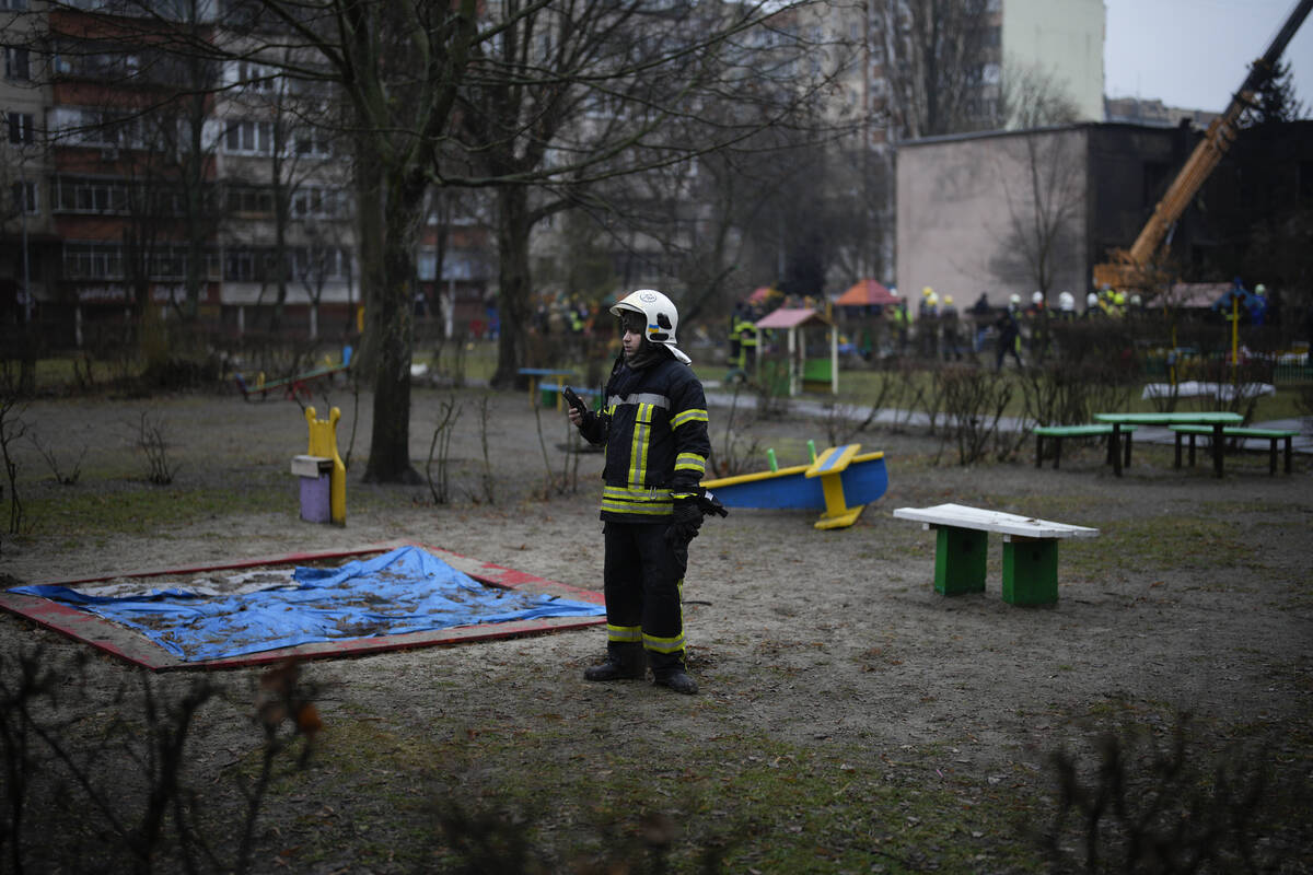 An emergency worker stands in a kindergarten at the scene where a helicopter crashed on civil i ...