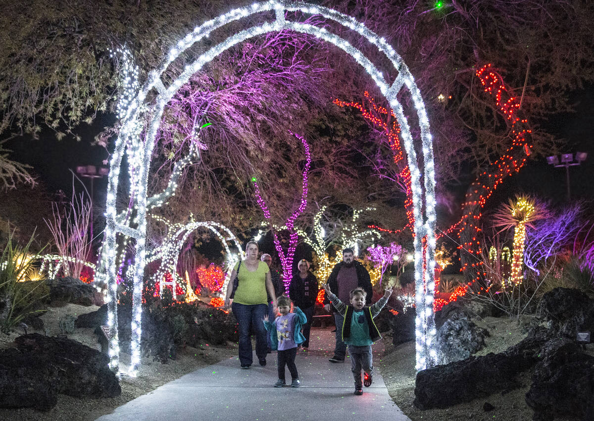 Liam and Paisley Quertin run through the gardens during the third annual Lights of Love event a ...