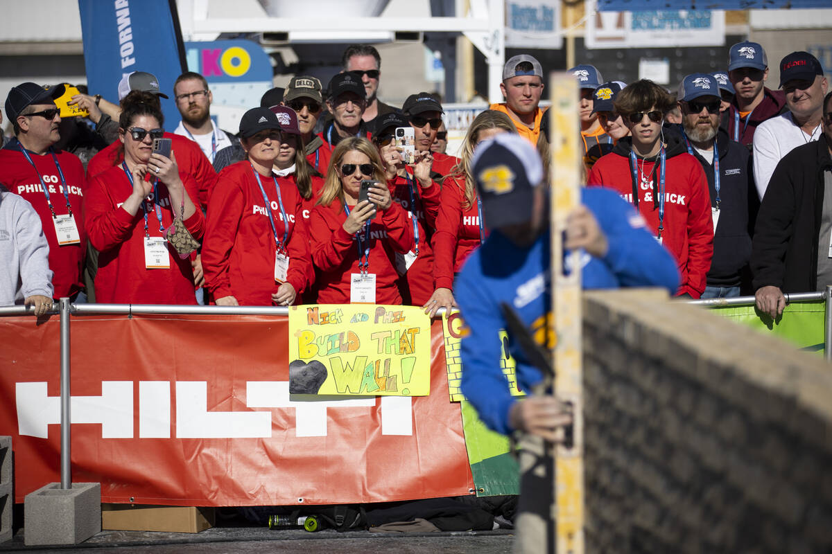 People watch Phil Bachetti participate in the World of Concrete Convention bricklaying competit ...