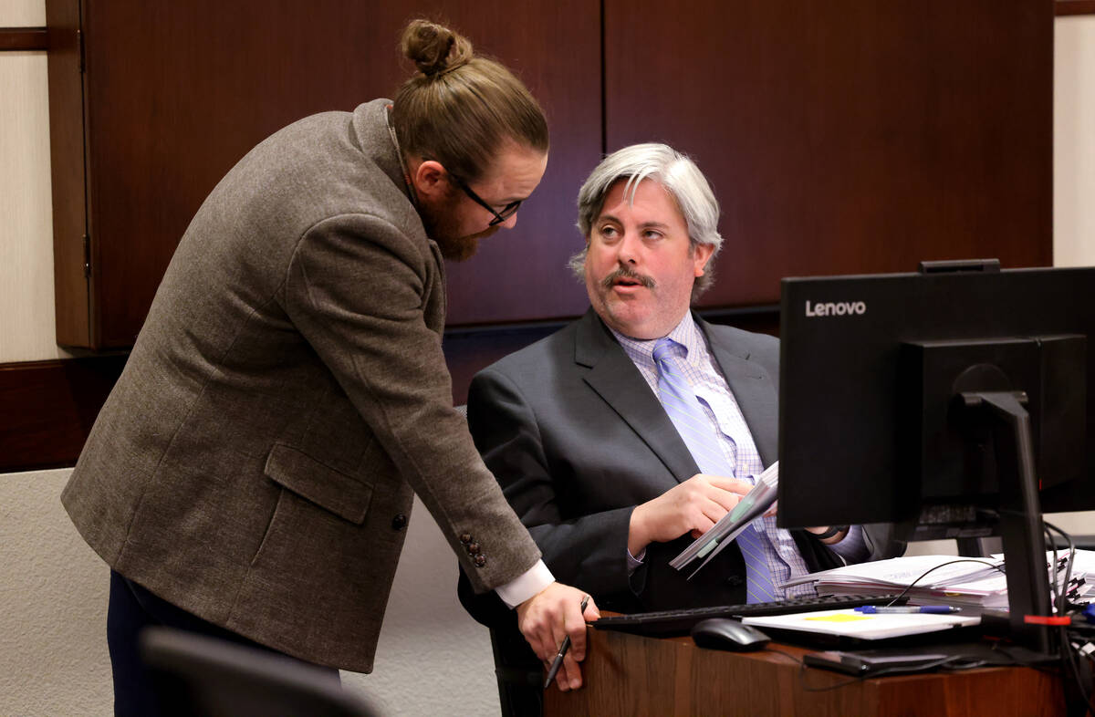 Adam Solinger, attorney for former Henderson police union President Gary Hargis, left, talks wi ...