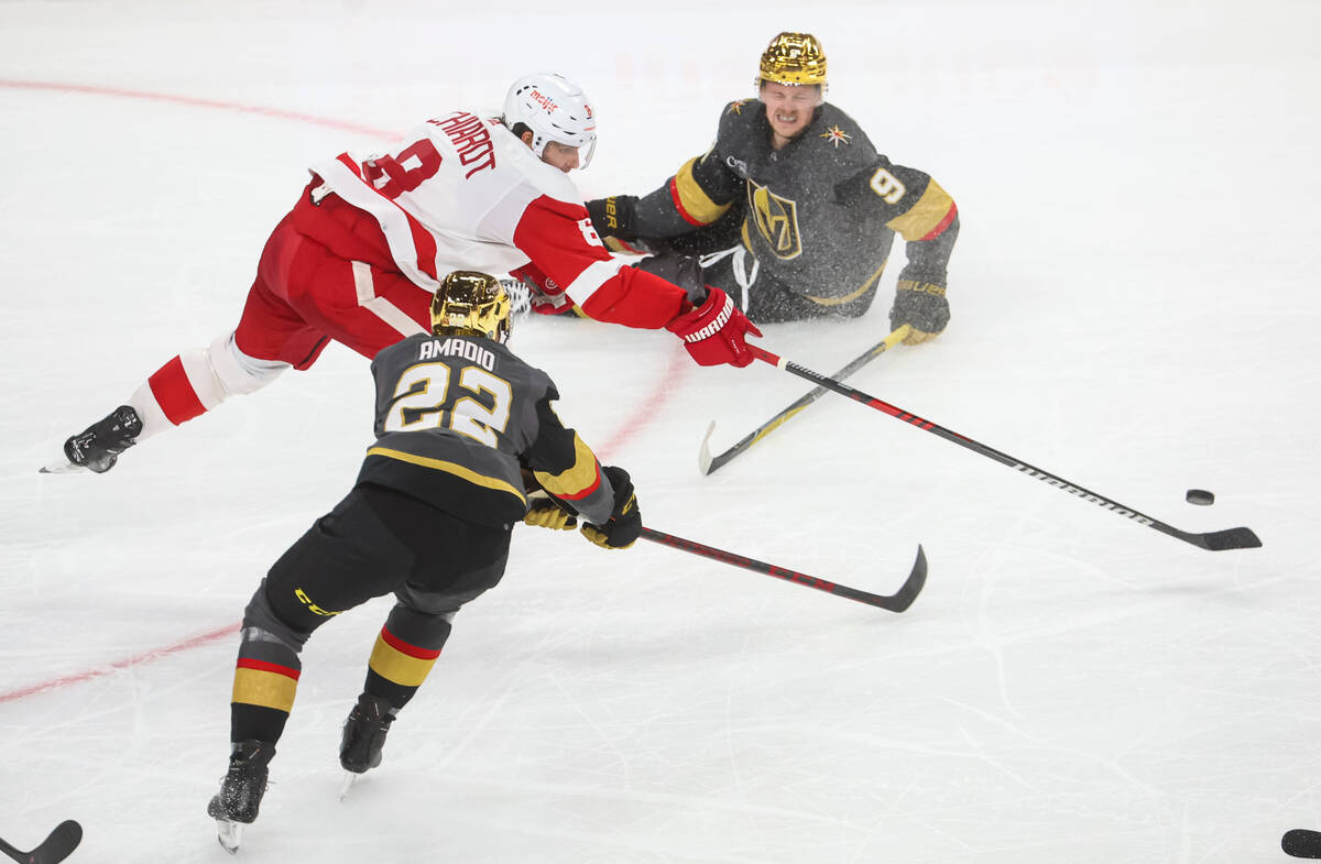 Golden Knights center Jack Eichel (9) falls to the ice as Detroit Red Wings defenseman Ben Chia ...