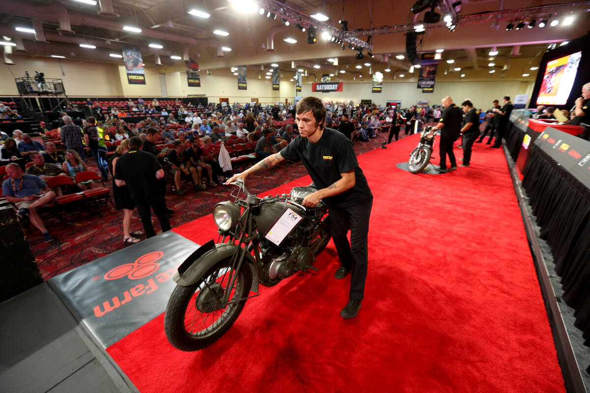 Aaron Hartley pushes a 1942 BSA M-20 during the Mecum Las Vegas Motorcycle Auction at the South ...
