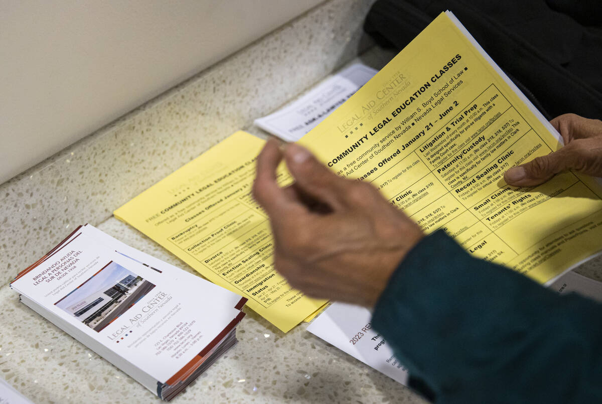 A man picks up informational papers at the Legal Aid Center of Southern Nevada on Tuesday, Jan. ...