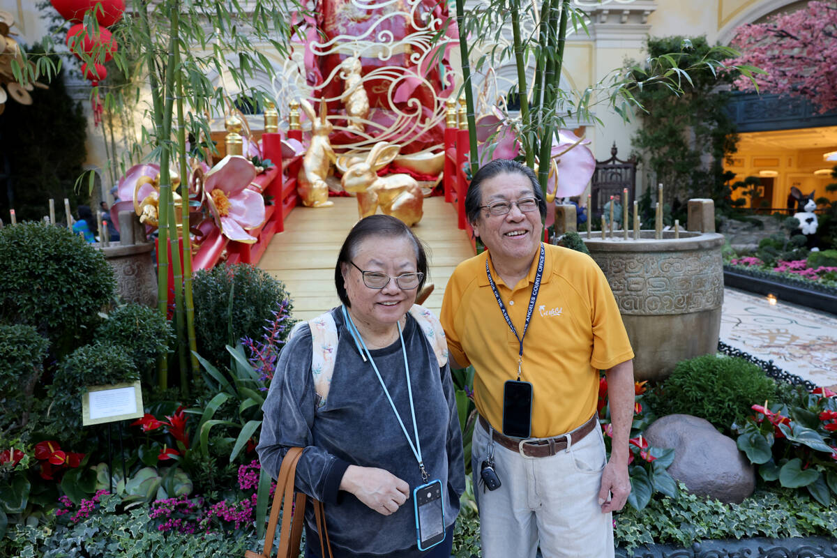 Linda and Steven Chin of Los Angeles pose with rabbits on a wooden bridge in the Year of the Ra ...