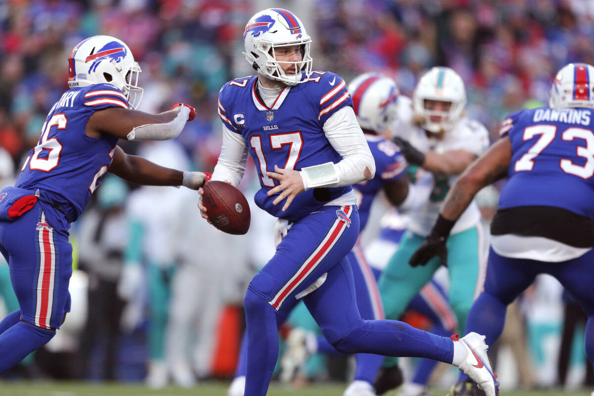 Buffalo Bills quarterback Josh Allen (17) runs a play during the second half of an NFL wild-car ...