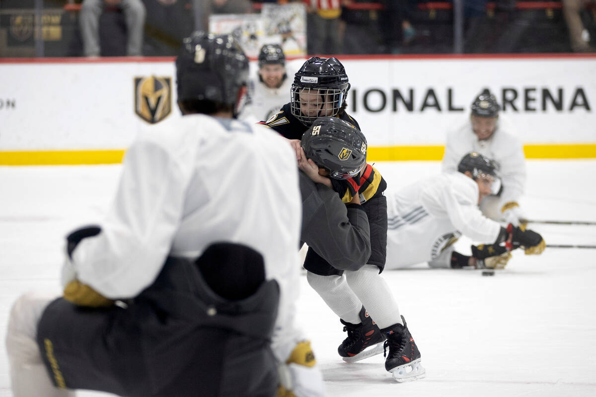 Annabelle Hanson, 8, fights with Golden Knights right wing Keegan Kolesar during practice City ...