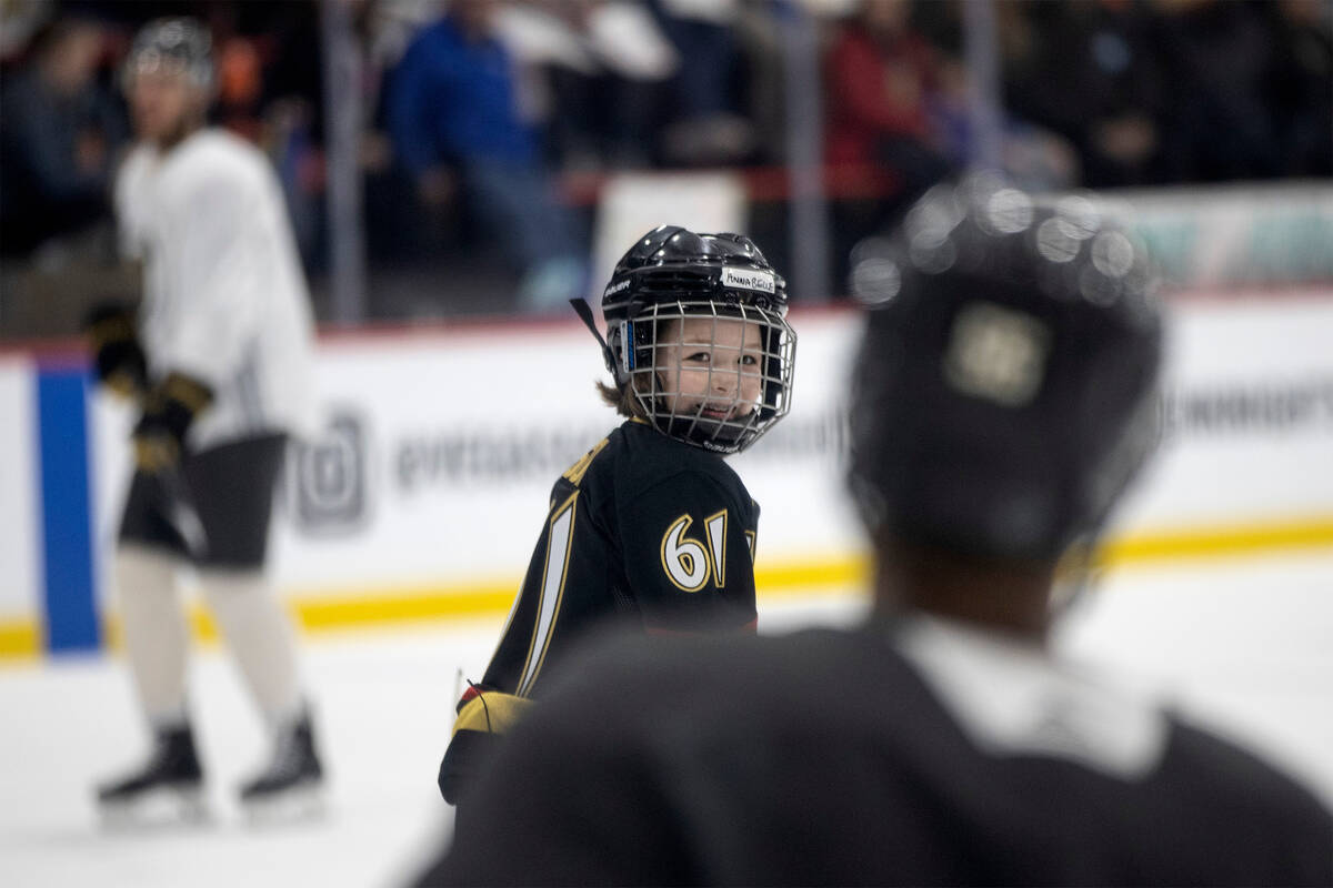 Annabelle Hanson, 8, laughs with Golden Knights right wing, left, during practice City National ...