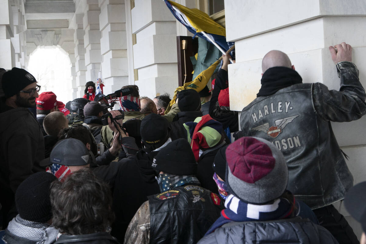 FILE - Insurrectionists loyal to President Donald Trump try to open a door of the U.S. Capitol ...