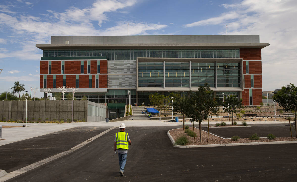 A construction worker approaches the under-construction medical education building of the Kirk ...