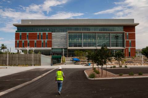 A construction worker approaches the under-construction medical education building of the Kirk ...