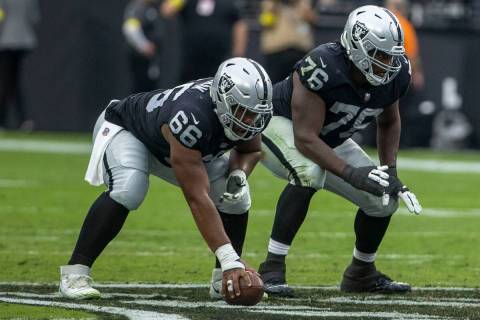 Raiders guard Dylan Parham (66) and Raiders guard John Simpson (76) get ready on the line of sc ...