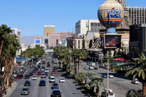 People and vehicles on the Strip at Bellagio Drive in Las Vegas Friday, Jan. 20, 2023. (K.M. Ca ...