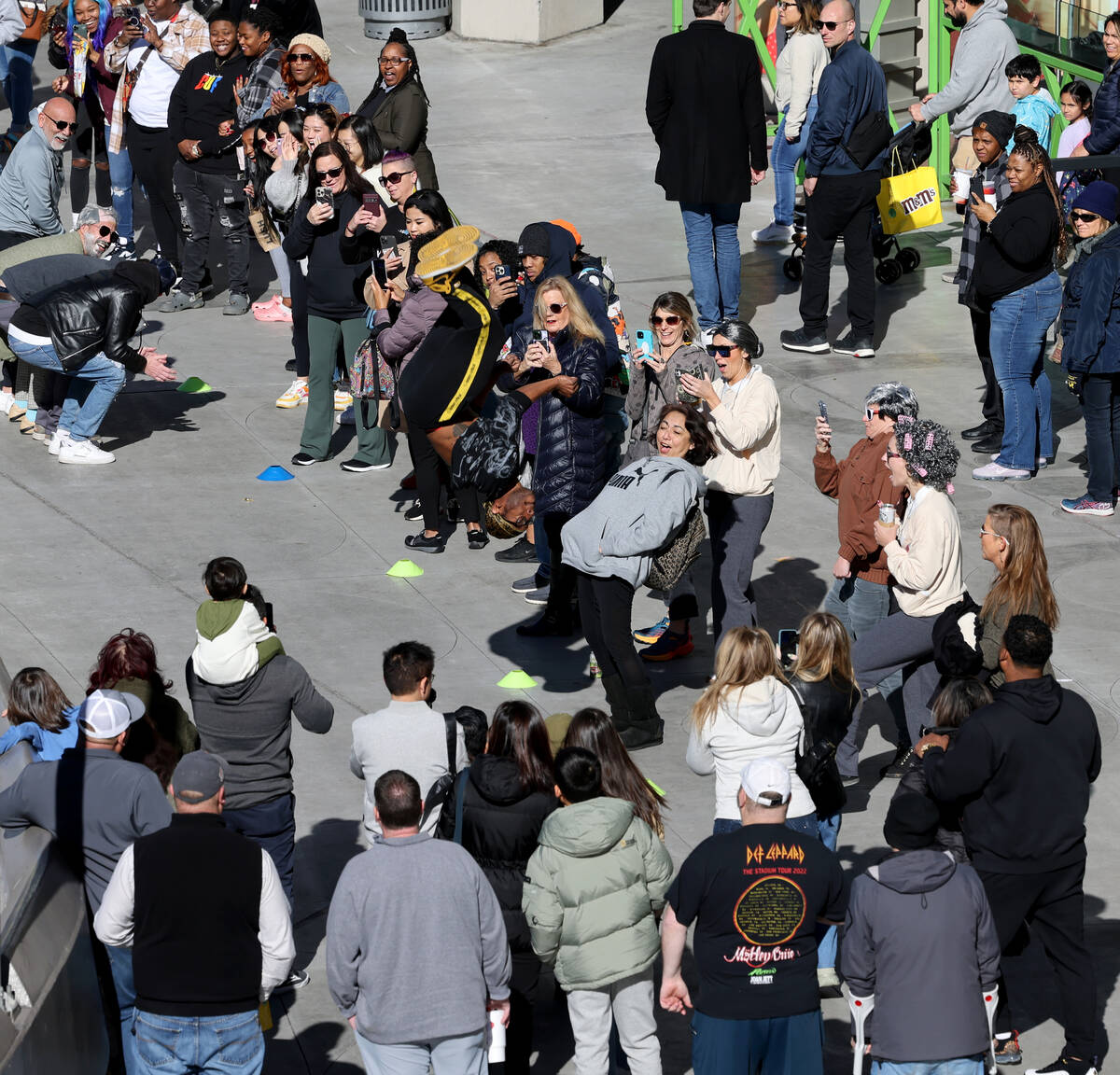 People watch an acrobat on the Strip near Harmon Avenue in Las Vegas Friday, Jan. 20, 2023. (K. ...