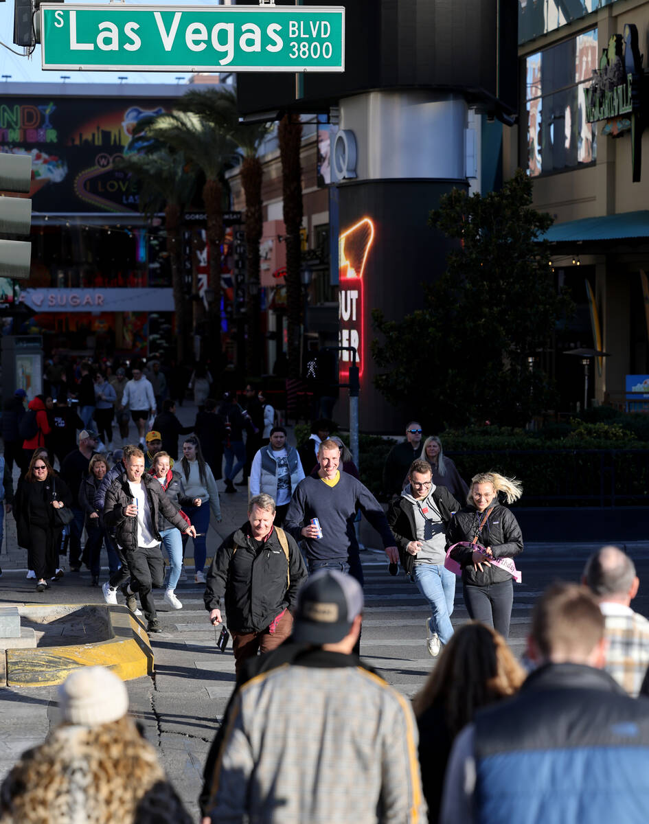 Pedestrians cross the Strip at The Linq Hotel in Las Vegas Friday, Jan. 20, 2023. (K.M. Cannon/ ...