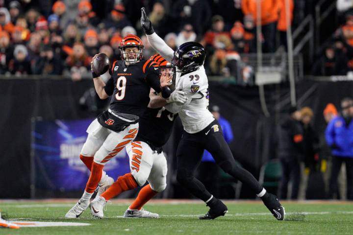 Cincinnati Bengals quarterback Joe Burrow (9) is sacked by Baltimore Ravens linebacker Odafe Ow ...