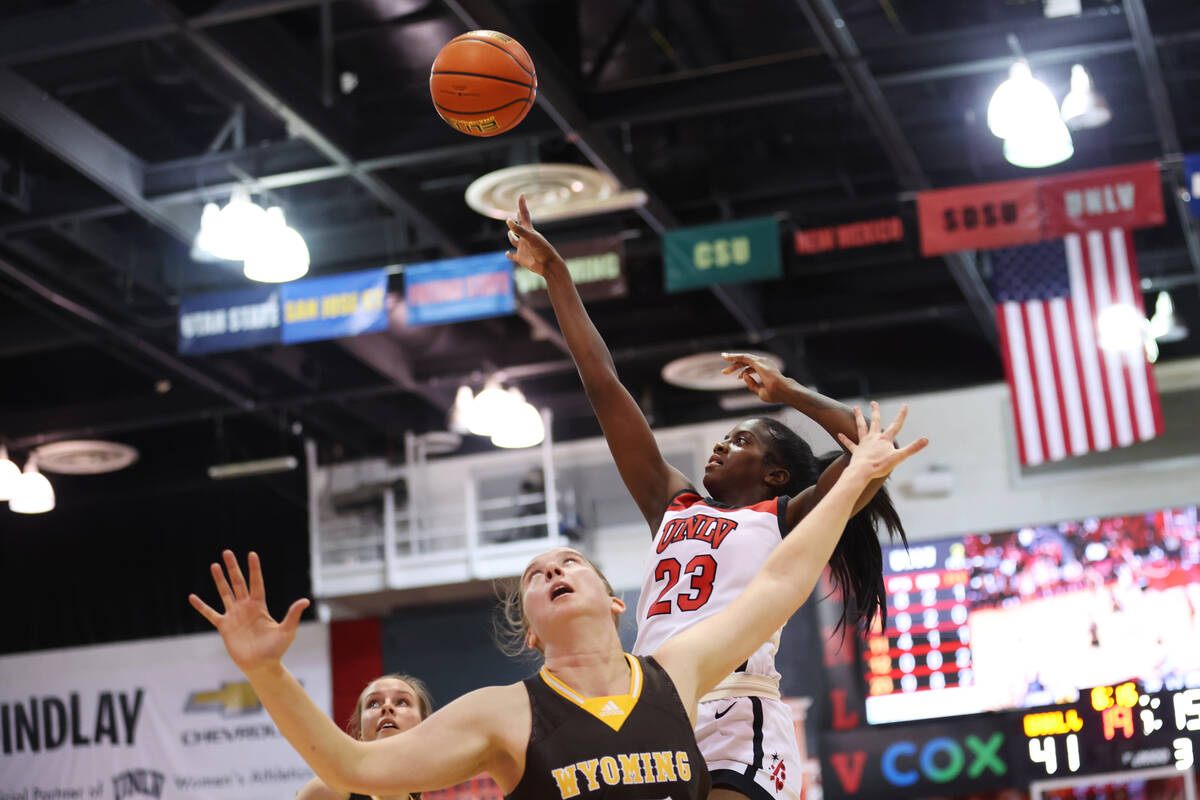 UNLV Lady Rebels center Desi-Rae Young (23) takes a shot over Wyoming Cowgirls center Allyson F ...