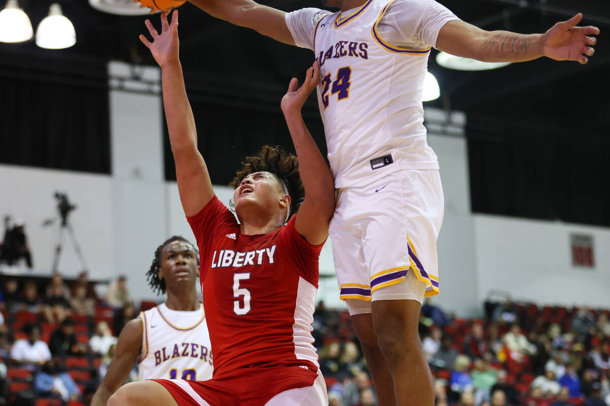 Durango's Taj Degourville (24) block a shot from Liberty's Andre Porter (5) during the first ha ...