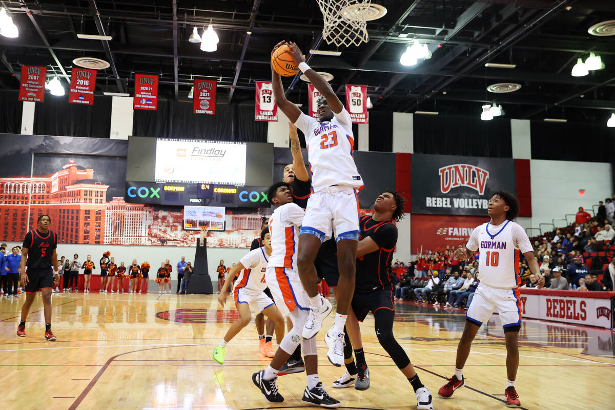 Bishop Gorman's Christopher Nwuli (23) grabs a rebound to end the game against Coronado during ...
