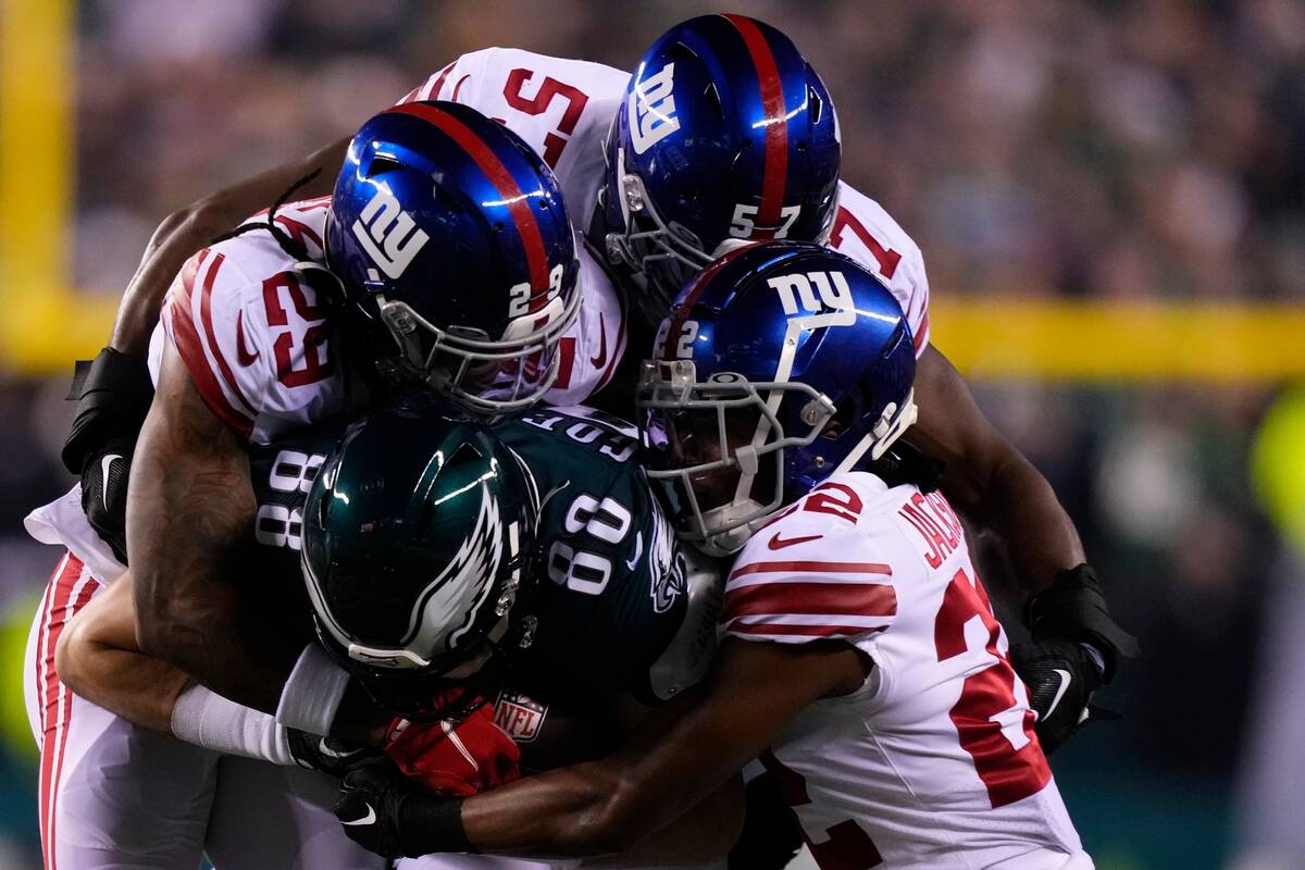 Philadelphia Eagles tight end Dallas Goedert (88) runs with the ball as New York Giants players ...