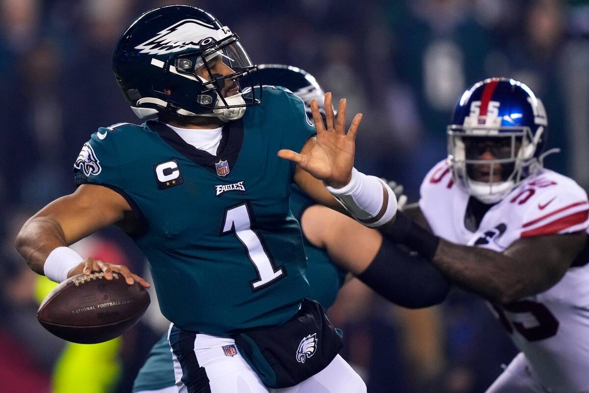 Philadelphia Eagles quarterback Jalen Hurts (1) throws a pass as New York Giants linebacker Jih ...