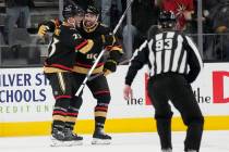 Vegas Golden Knights defenseman Alec Martinez, left, celebrates after scoring against the Washi ...