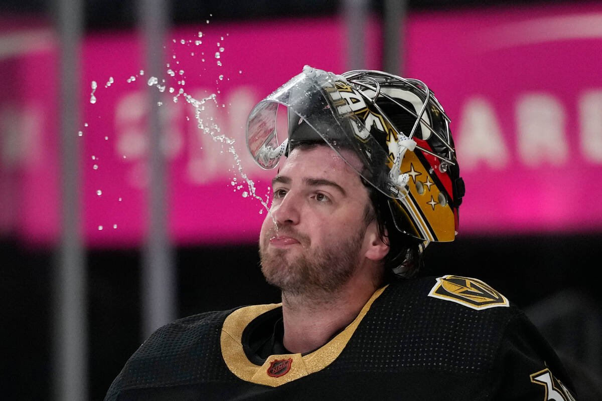Vegas Golden Knights goaltender Logan Thompson (36) spits out water during the third period of ...