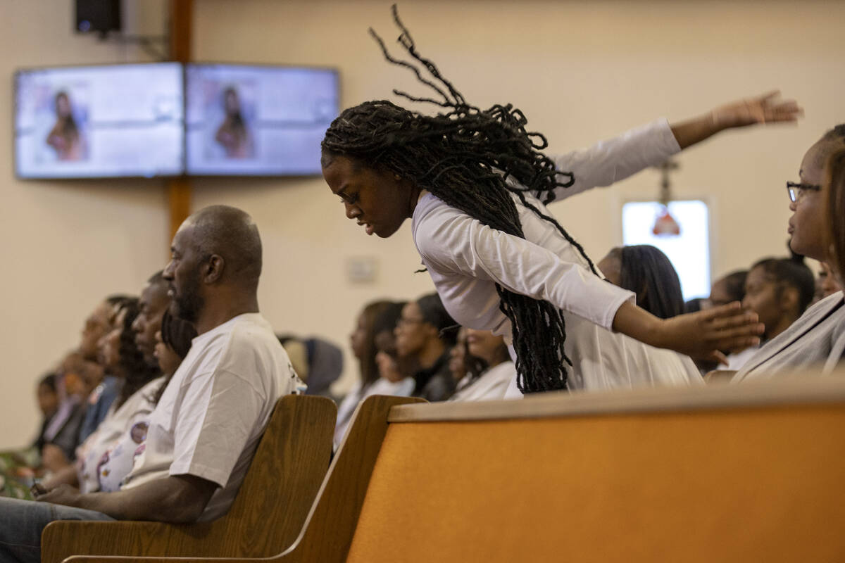 A dancer moves between pews during a memorial for Ashari Hughes at New Bethel Baptist Church on ...