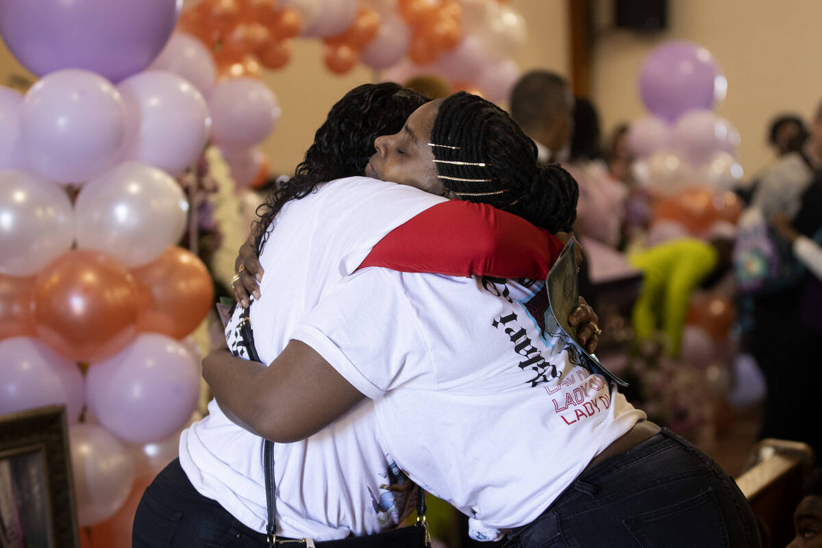 Loved ones of Ashari Hughes embrace during a memorial for the 16 year old at New Bethel Baptist ...