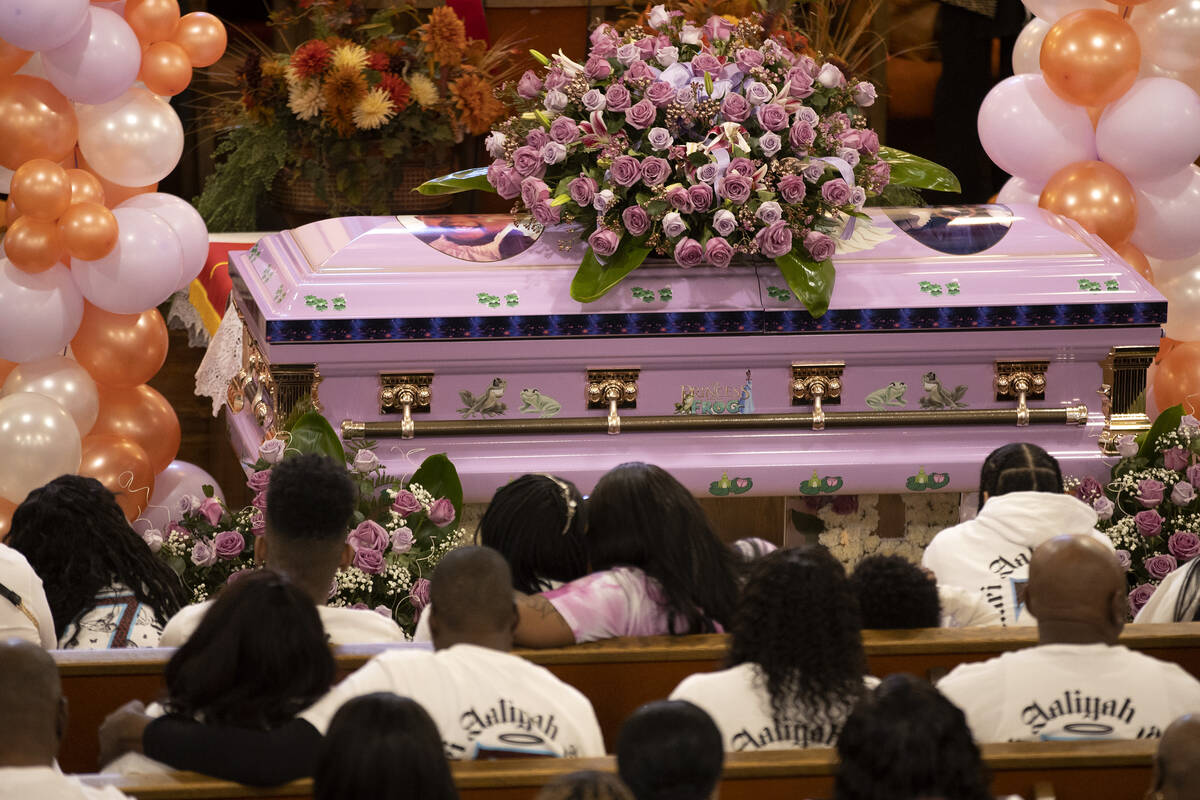 Ashari Hughes’ casket is adorned with her photo and flowers during a memorial for the 16 ...