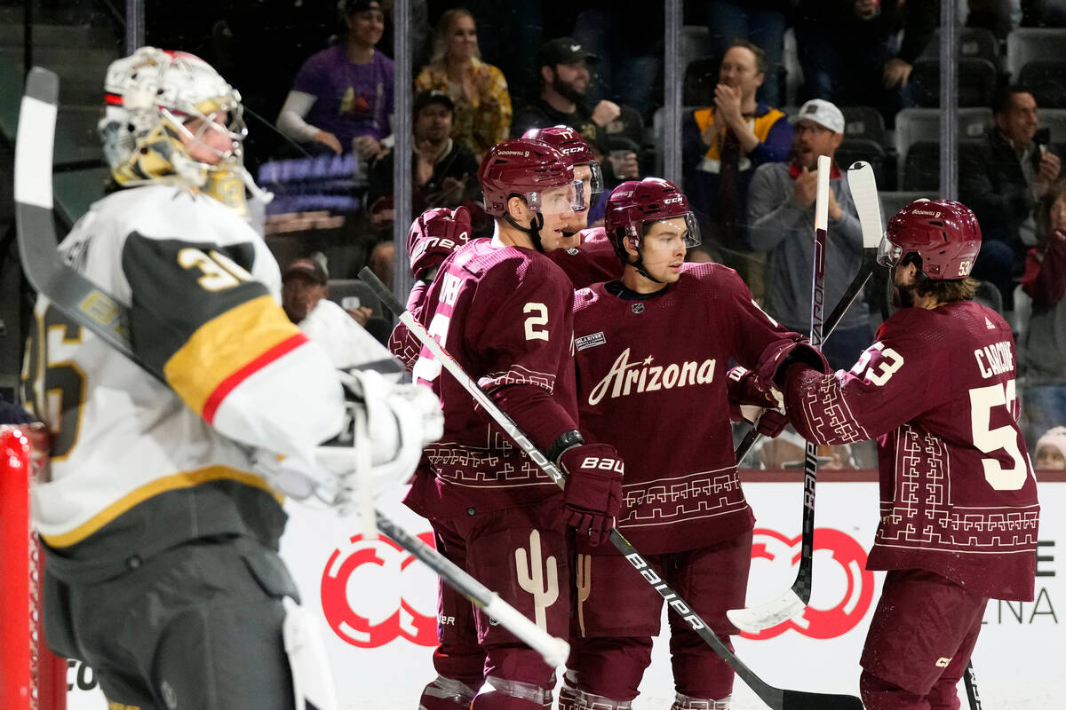 Arizona Coyotes right wing Dylan Guenther, second from right, celebrates with defenseman Patrik ...