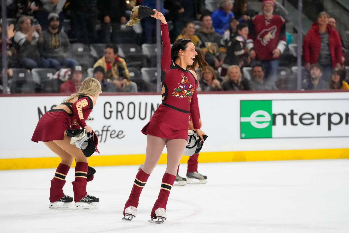 Arizona Coyotes Ice Trackers pick up hats from the ice after Coyotes' Clayton Keller recorded a ...