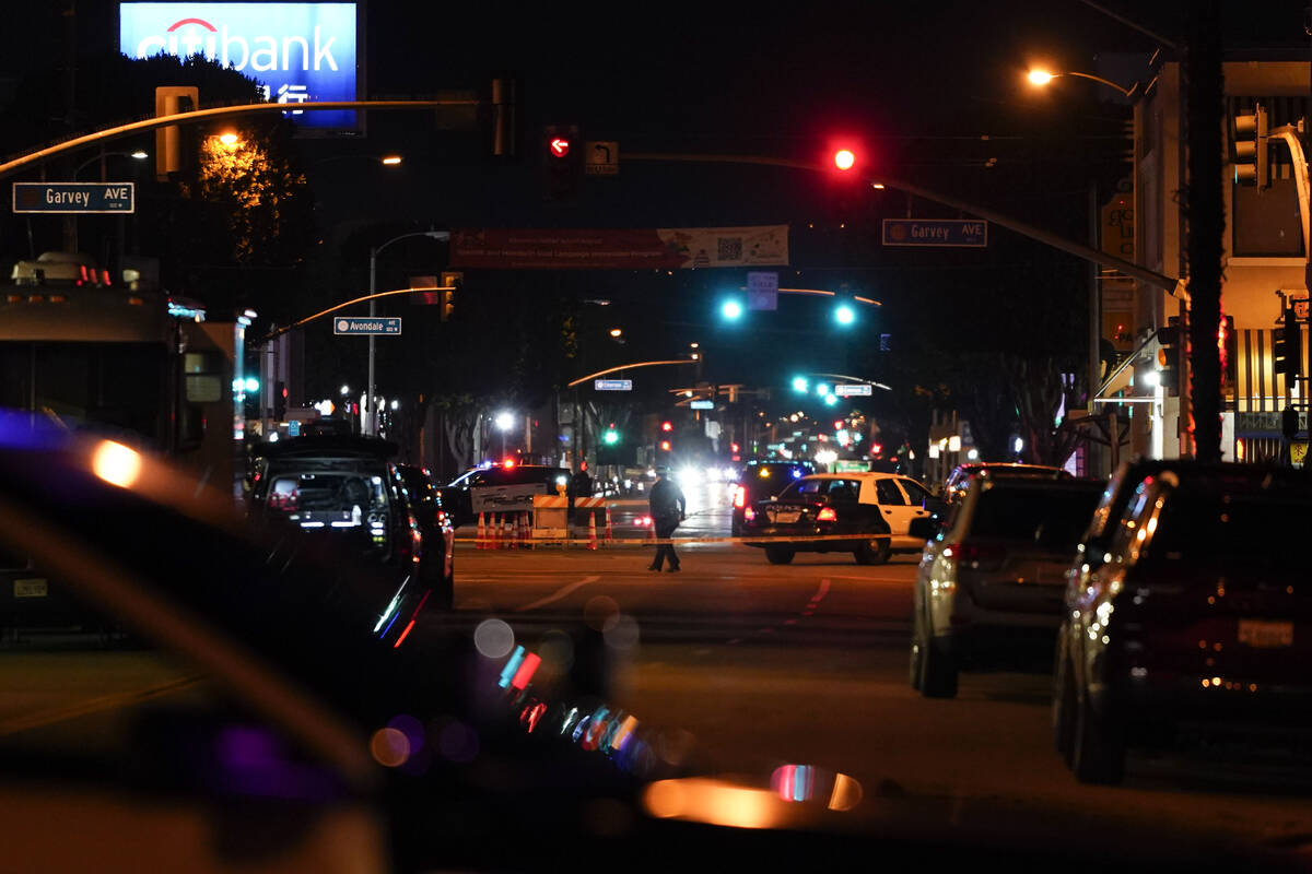 Police investigate a scene where a shooting took place in Monterey Park, Calif., Sunday, Jan. 2 ...