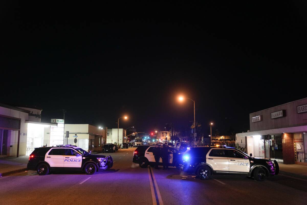 Police vehicles block the street near a scene where a shooting took place in Monterey Park, Cal ...