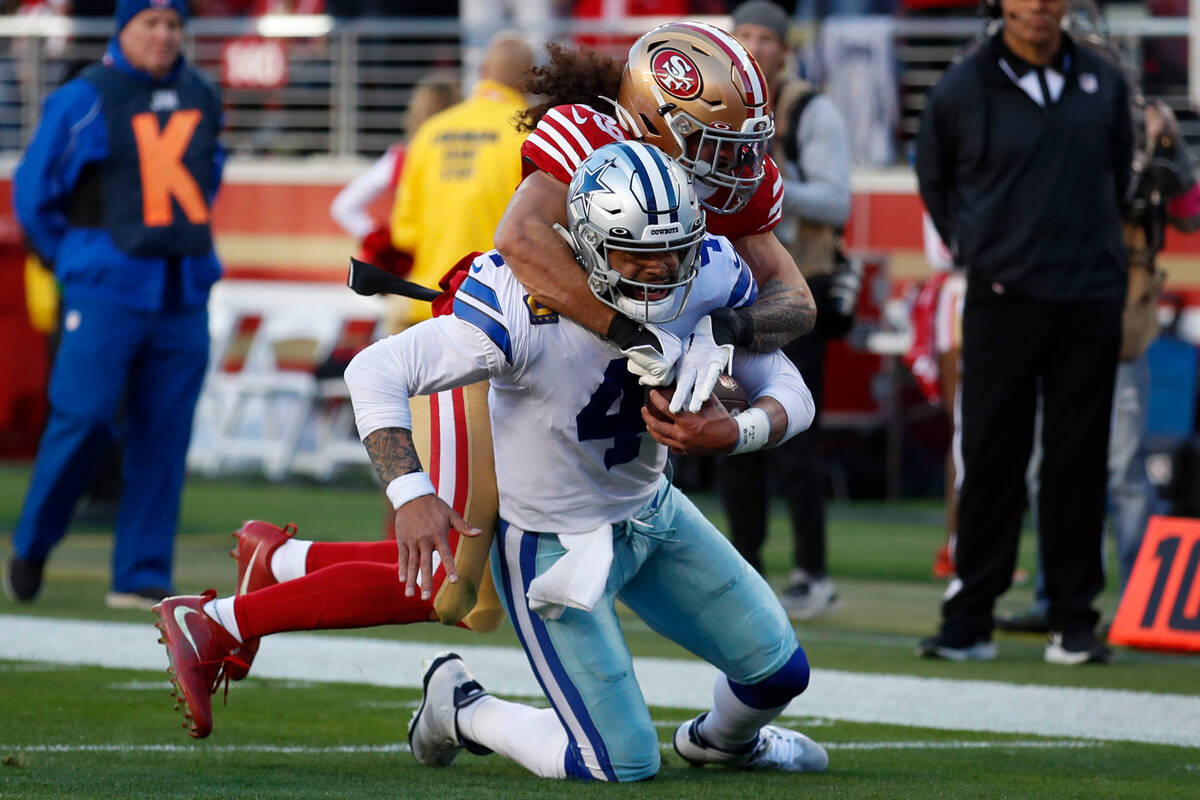 Dallas Cowboys quarterback Dak Prescott (4) is tackled by San Francisco 49ers safety Talanoa Hu ...