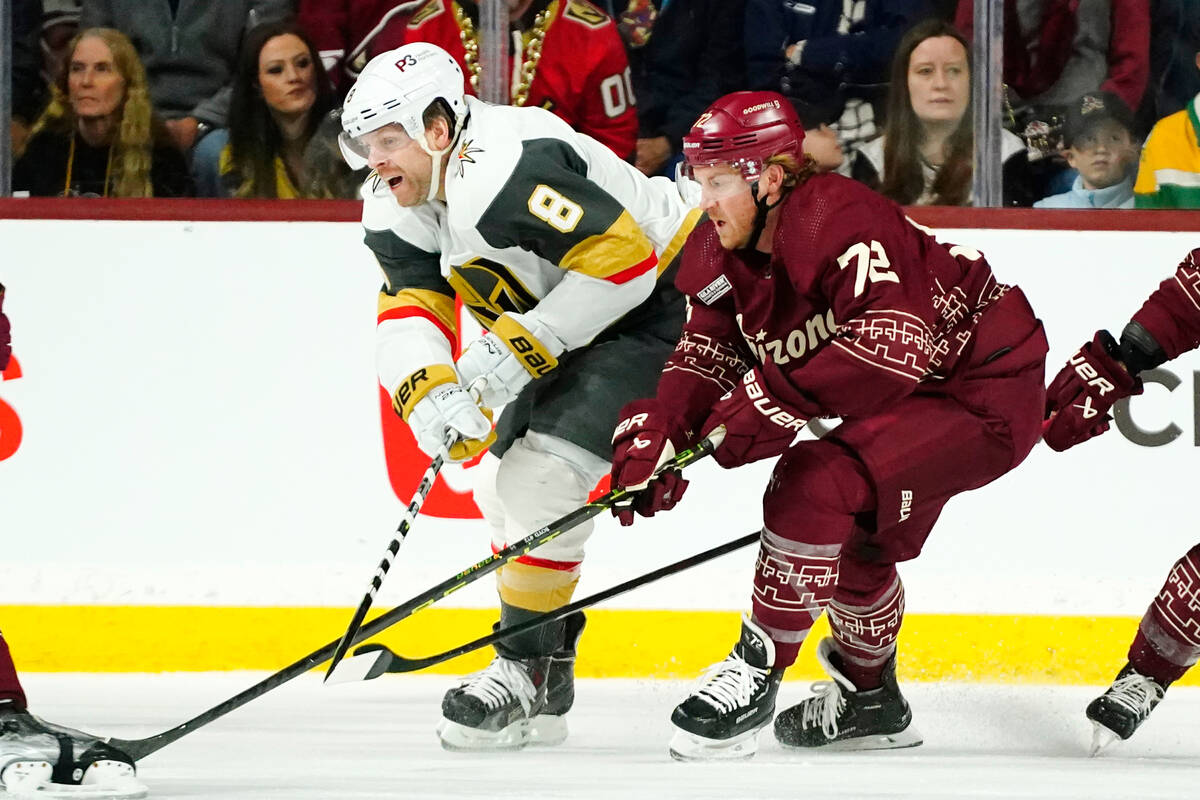 Vegas Golden Knights right wing Phil Kessel (8) and Arizona Coyotes center Travis Boyd (72) bat ...