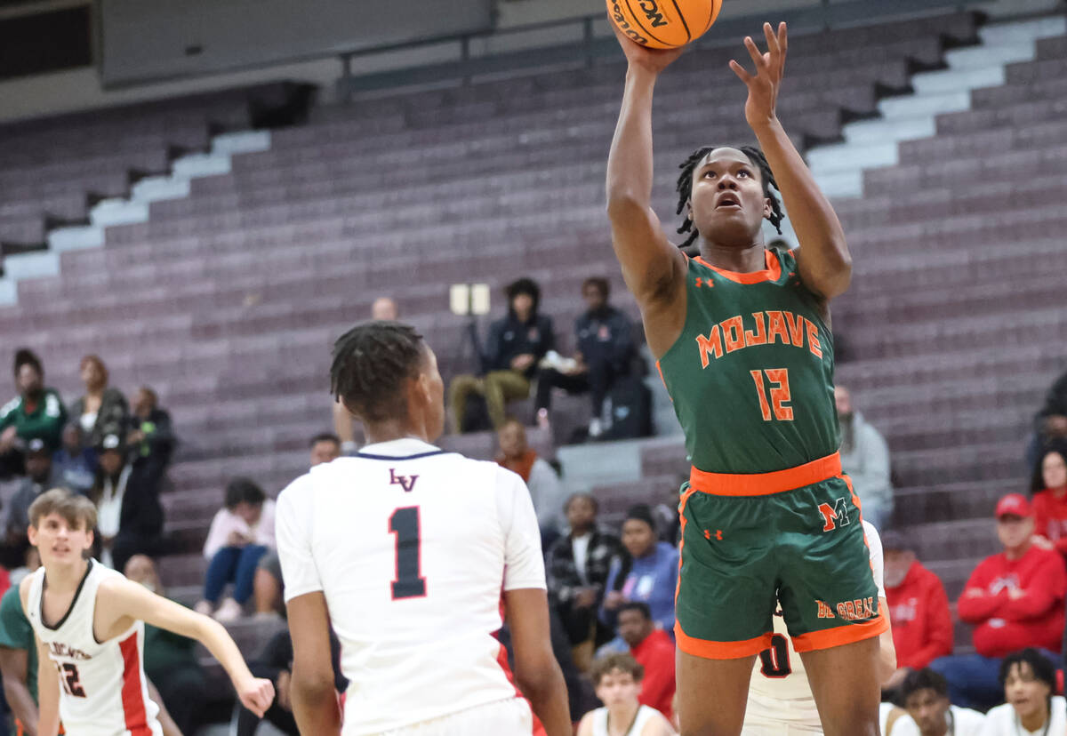 Mojave's Montez Simmons (12) shoots over Las Vegas' Naseer Sims (1) during the first half of a ...