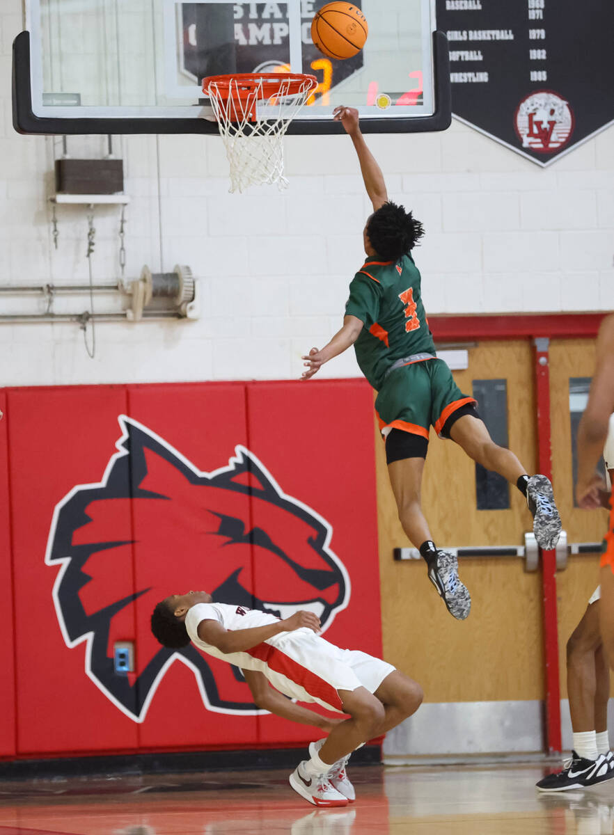 Mojave's C.J. Shaw (3) lays up the ball over Las Vegas' Tayshaun Jackson (3) during the second ...
