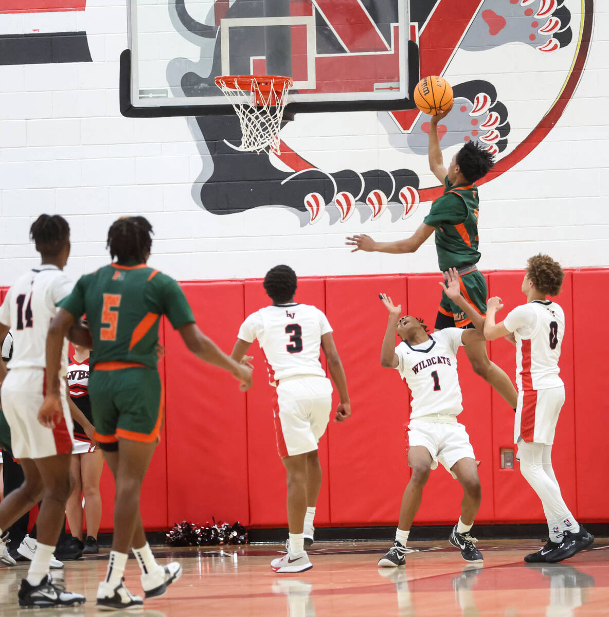 Mojave's C.J. Shaw (3) lays up the ball around Las Vegas' Naseer Sims (1) during the first half ...