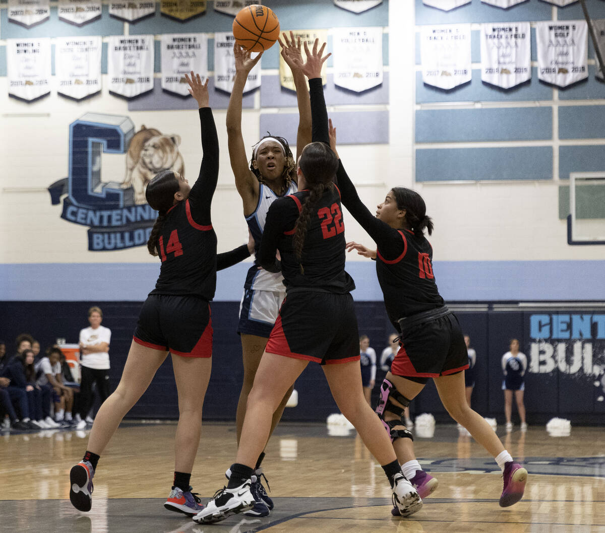 Centennial’s Cici Ajomale, center, passes to a teammate while Coronado’s Kaylee W ...