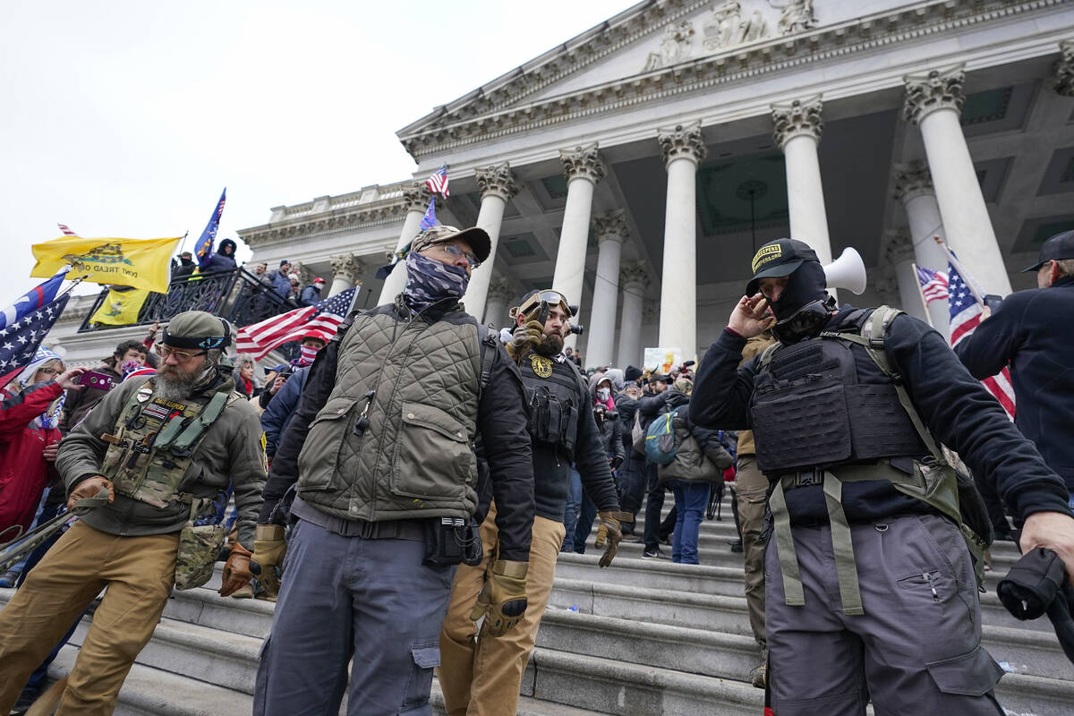 FILE - Members of the Oath Keepers extremist group stand on the East Front of the U.S. Capitol ...