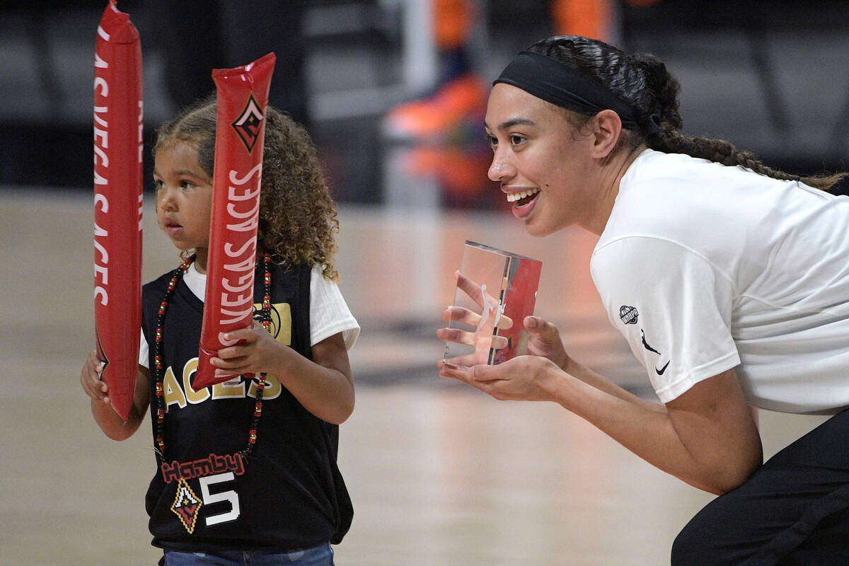 Las Vegas Aces forward Dearica Hamby, right, poses with her daughter Amaya, left, after being p ...