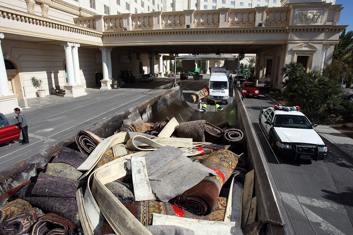 Workers from Belfor Property Restoration load pieces of carpet emoved from the Monte Carlo hote ...