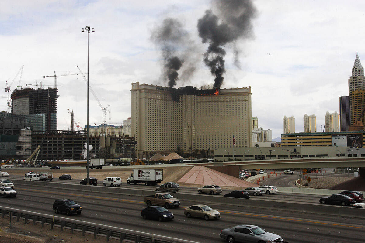 Black smoke billows up from the Las Vegas Strip as a three-alarm fire burns at the Monte Carlo ...