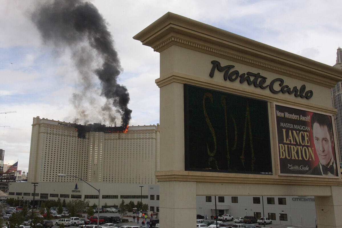 Black smoke billows up from the Las Vegas Strip as a three-alarm fire rages at the Monte Carlo ...