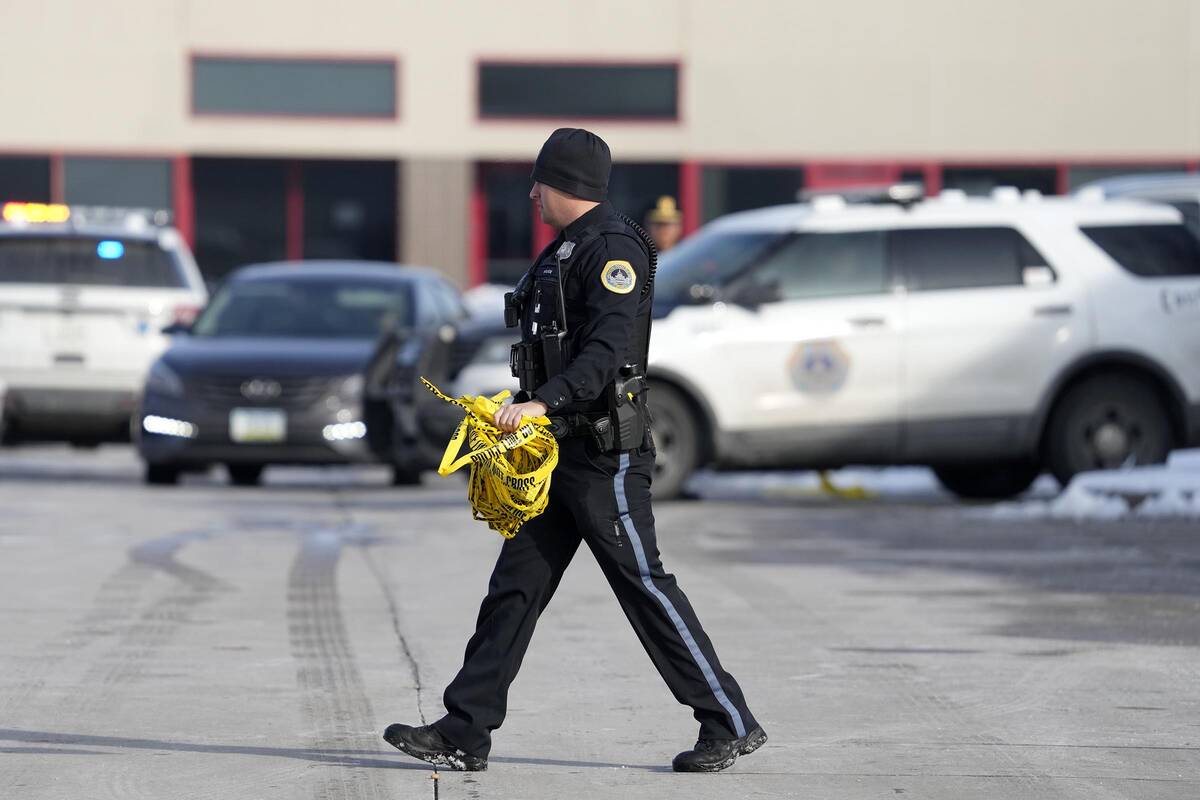 A law enforcement officer walks outside the Starts Right Here building, Monday, Jan. 23, 2023, ...